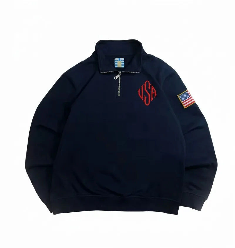 ‘EIPSTEIN’ sweater in navy. Embroidered logo. Flag at the sleeve.